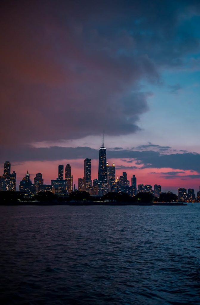 Capture the beauty of Chicago's skyline at dusk, with vibrant skies and illuminated buildings.